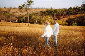 Couple Walking Through Field